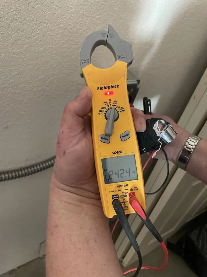 Voltage testing with clamp meter during Electrical Installation Services in East Rochester